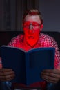 Frighten man reading horror Royalty Free Stock Photo