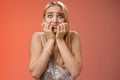 Frightened afraid panicking young cute blond woman biting nails pop eyes scared camera look terrified stunned speechless Royalty Free Stock Photo