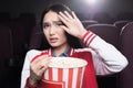 frightened asian girl eating popcorn and watching movie Royalty Free Stock Photo
