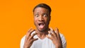 Frightened Black Man Screaming In Fear Standing Over Orange Background