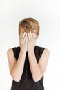 Frightened boy covering his face with both hands Royalty Free Stock Photo