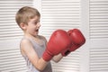 Frightened boy in red boxing gloves. Royalty Free Stock Photo