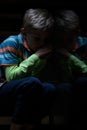 Frightened boy sitting on stairs Royalty Free Stock Photo