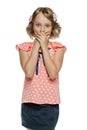 Frightened little girl standing with hands over mouth Royalty Free Stock Photo