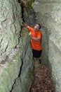 A frightened man, stuck between rocks and he`s having fun