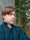 Frightened Man in Woods, Terrified Expression, Back Against Tree Royalty Free Stock Photo