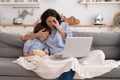 Mom and kid son with bowl of popcorn watching scary movie closing their eyes sitting on sofa at home Royalty Free Stock Photo