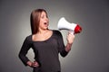 Frightened woman looking on megaphone