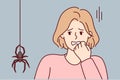 Frightened woman puts hand to face sees large spider descending from ceiling along web. Vector image