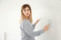 Frightened woman with tablet using security system indoors Royalty Free Stock Photo