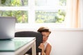 Frightened Businesswoman Hiding Behind Chair