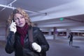 Frightened Young Woman On Cell Phone in Parking Structure