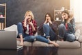 Frightened young women watching movie at home Royalty Free Stock Photo