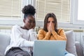 Frightened young women watching movie at home. Girls watching a terror movie on tv sitting on a couch at home. Girlfriends Royalty Free Stock Photo