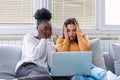 Frightened young women watching movie at home. Girls watching a terror movie on tv sitting on a couch at home. Girlfriends Royalty Free Stock Photo