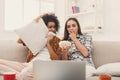 Frightened young women watching movie at home Royalty Free Stock Photo