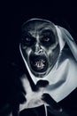 Frightening evil nun with bloody teeth