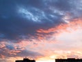 Frighteningly beautiful pink-burgundy sunset with feathery-layered clouds