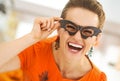 Woman in party bat glasses in the Halloween decorated kitchen Royalty Free Stock Photo