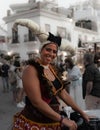 Frigiliana, Malaga, Spain, August 27, 2022: street performer with medieval headdress of horns