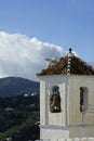 Charming old church, Frigiliana village, Spain. Close up view of bell tower.