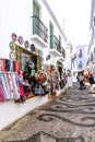 A narrow steep shopping alley in Frigiliana, one of Andalucia`s famous `White Villages` on the Costa del Sol in Southern Spain.