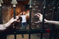 Frigtened girl meet prisoner in the dungeon. Bony hands stretch through the bars