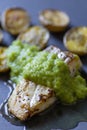 frilled cod fish with green asparagus pea sauce and fried potatoes Royalty Free Stock Photo