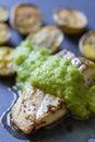 frilled cod fish with green asparagus pea sauce and fried potatoes Royalty Free Stock Photo