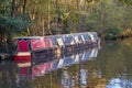 English canal narrow boat with Autumn fall leaves on trees