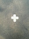 Sticky plaster stuck in a cross on the sidewalk. Royalty Free Stock Photo