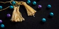 fringe, made of yellow silk thread, beads, blue and lilac, on a black background, Royalty Free Stock Photo