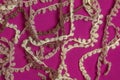 Fringe of a warm beige woolen scarf on a lilac-burgundy background