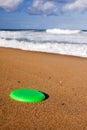 A Frisbee on the beach sand Royalty Free Stock Photo