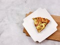 Frittata with potatoes, green peas, cheese and sausages on a white rectangular plate served on a wooden cutting board Royalty Free Stock Photo