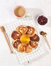 Fritters with cherries, honey and coffee on a light background. The concept of healthy and natural food. Healthy breakfast with