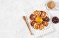 Fritters with cherries, honey and coffee on a light background. The concept of healthy and natural food. Healthy breakfast with