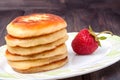 Fritters on a plate with strawberries isolated white background Royalty Free Stock Photo