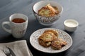 Fritters of zucchini with dill in a deep dish, tea, sour cream