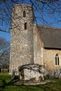 Round church tower knapped flint stone, against blue sky. Royalty Free Stock Photo