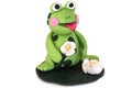 Frog figurine made of polymer clay on a white background