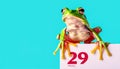 Frog sitting atop a calendar marked with February 29. Leap Day Calendar Date