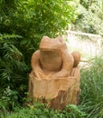 A frog statue carved out of wood