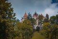 Frog view of Bran castle or famous Dracula's castle, close to Bran, Romania on a cloudy summer day Royalty Free Stock Photo