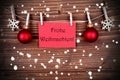 Frohe Weihnachten on a Red Banner in the Snow