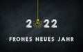 Frohes neues Jahr 2022. Happy New Year in Germany Idiom On chalkboard. Creative Concept. 2022 Light Bulb On Blackboard with German Royalty Free Stock Photo