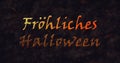 Frohliches Halloween text in German dissolving into dust to bottom