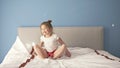 Frolicsome little girl having fun jumping on bed.