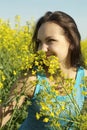 Frolicsome young girl in the middle of yellow flowers Royalty Free Stock Photo