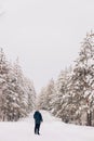 Photographer in winter frost covered forest